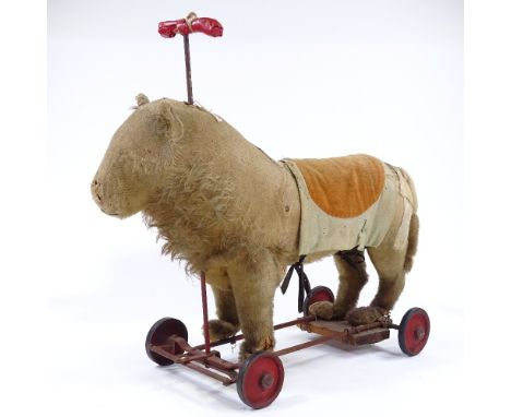 An Antique Steiff straw-filled ride-on soft toy lion, with growler, length 50cm 