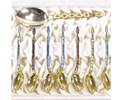 A set of 12 Norwegian sterling silver-gilt and coloured enamel coffee spoons, and matching caddy spoon, in Viking revival sty