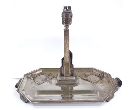 A large Art Deco octagonal silver desk stand, with central stepped lamp, opposing inkwell bases and pen tray, by Thomas Bradb