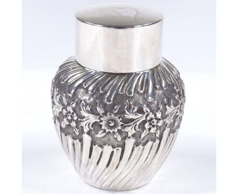 An Art Nouveau circular silver tea caddy, of half-fluted form with relief embossed floral decoration, by Thomas Latham and Er