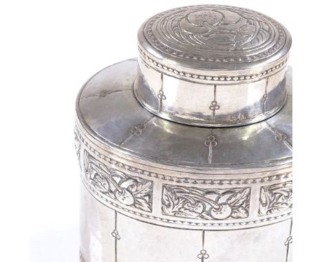 A Liberty &amp; Co oval silver tea caddy, with relief embossed Arts and Crafts fruit designs, hallmarks Birmingham 1917, heig