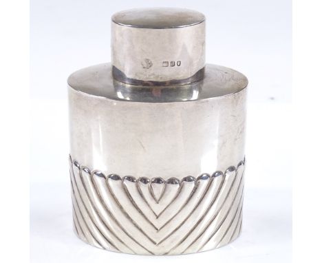 A small oval silver tea caddy, of half-fluted form, by William Hutton &amp; Sons Ltd, hallmarks London 1903, height 8cm, 1.6o