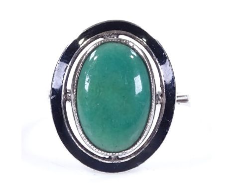 An Art Deco sterling silver green stone and black enamel panel ring, with pierced settings and closed back, setting height 18