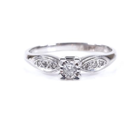 A 9ct white gold solitaire diamond ring, with diamond set shoulders, total diamond content approx 0.1ct, setting height 4.4mm
