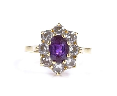 An 18ct gold amethyst and diamond cluster ring, total diamond content approx 0.8ct, setting height 13.4mm, size K, 3.7g 