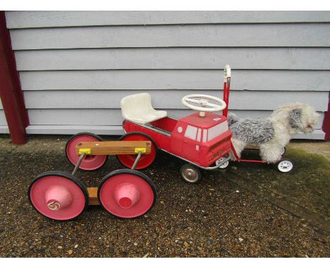 A child's ride on fire engine, push along dog and set of pedal wheels