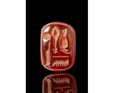 New Kingdom, Ca. 1550 - 1069 BC. A carnelian stamp seal with a rectangular face containing the name of the God Amun-Re. The b