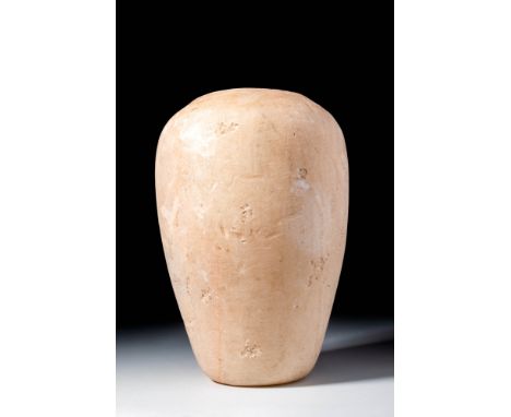 Old Kingdom, Ca. 2900 - 2200 BC. A fine alabaster canopic jar with a rounded body tapering to a flat base. The surface is smo