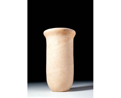 Old Kingdom, Ca. 2900 - 2200 BC. A tall alabaster vessel with a cylindrical body that tapers slightly towards the base and ex