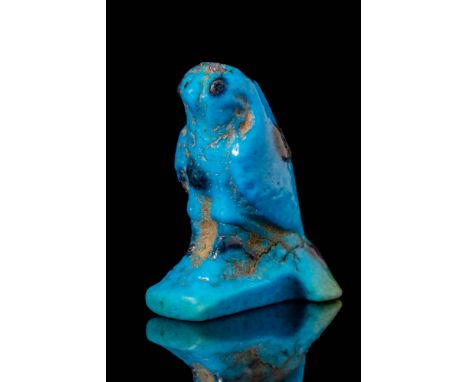 Third Intermediate Period, Ca. 1069 - 664 BC. A blue faience amulet depicting a falcon, representing Horus, with a compact bo