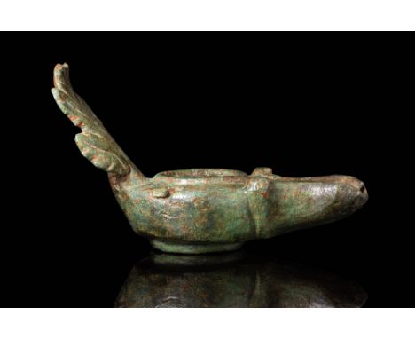 Ca. AD 1 - 100.A bronze oil lamp with a rounded body, a slightly recessed discus with a central filling hole, and a short noz