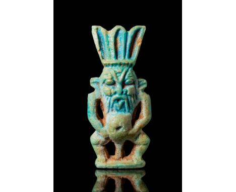 New Kingdom - Third Intermediate Period, Ca. 1550 - 664 BC. A blue faience amulet depicting Bes, the protective deity associa