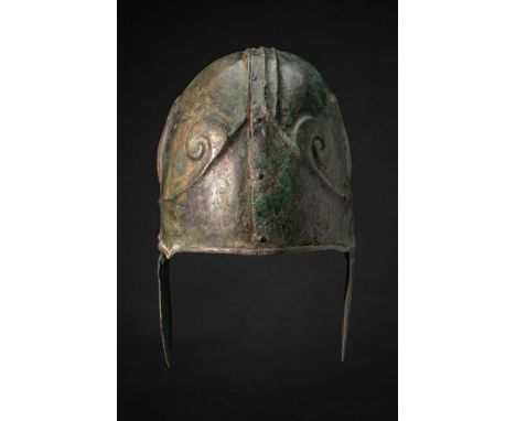 Ca. 350 - 250 BC. A Chalcidian bronze helmet formed from two joined halves, the seam running vertically through the centre of