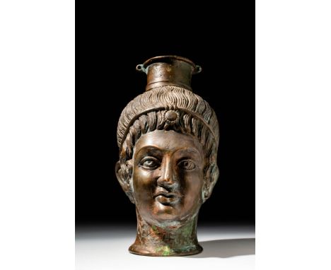 CA. 1900 AD OR EARLIER . A bronze flask in the form of a youthful male head. The vessel is cast with finely modelled facial f