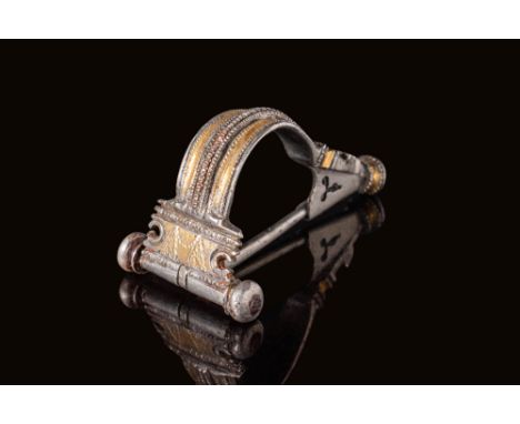 Ca. 100 BC - AD 100. A silver-gilt brooch of Aucissa type, composed of an arched bow with raised central rib flanked by beade