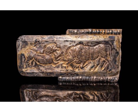 Ca. 500 BC. A rectangular silver-gilt belt fitting with a scene of a lion attacking a bull in profile. The animals are shown 