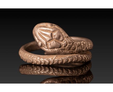 Ca. 100 BC - AD 100. A silver ring with a coiled, overlapping band. The outer surface is engraved with a pattern resembling s