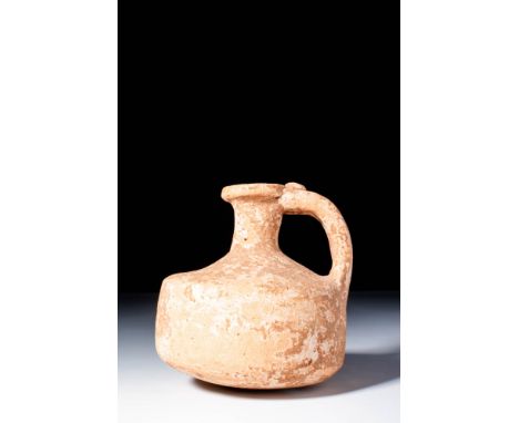 Ca. AD 1 - 300. A terracotta jug with a wide cylindrical body, sloping shoulder, and a short neck leading to a pronounced rim