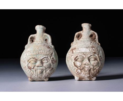 Ca. 30 BC - AD 200. A pair of turquoise-glazed faience flasks, each with a rounded and flattened body, and a short, cylindric