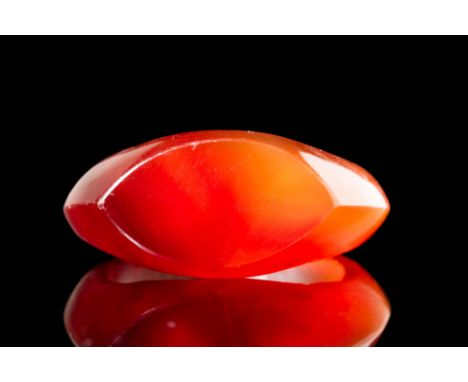 New Kingdom, Ca. 1550 - 1069 BC. A D-shaped carnelian ring with a broad, flat bezel of elongated shape, tapering to pointed e
