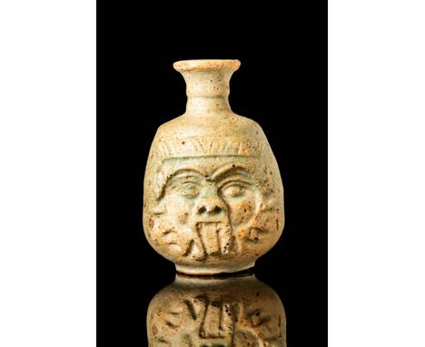 Late Period, Ca. 664 - 332 BC. A faience bottle with a short, funnel-shaped neck and a rounded body decorated with a moulded 