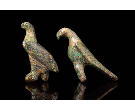 Ca. AD 200 .A pair of bronze eagles, each rendered with characteristic hooked beak and folded wings with incised detailing. B