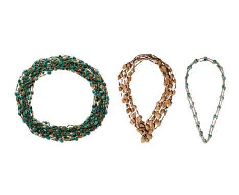Ca. AD 1900.A collection of three multi-strand necklaces incorporating scarabs and metal chain links. The first necklace is c