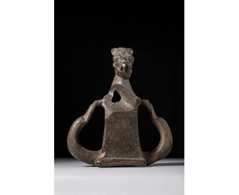 Ca. AD 1 - 200. A heavy bronze chariot fitting with two curving lateral projections and a central rectangular body. At the to