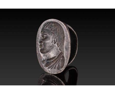 Ca. AD 500 - 300. A rare and sizeable silver ring with a broad, rounded hoop that thickens towards the shoulders, supporting 