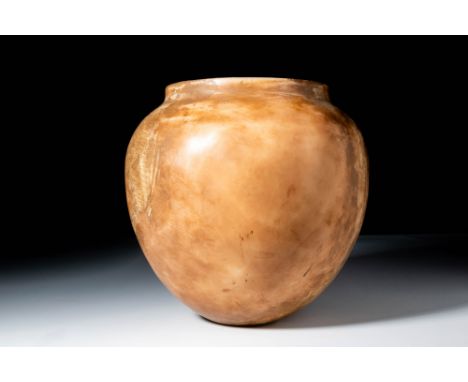 Middle Kingdom, Ca. 2055 - 1790 BC. A kohl pot carved from alabaster with an ovoid body tapering towards the base and a short