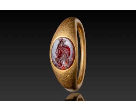 Ca. AD 100 - 200. An oval-shaped intaglio depicting the bust of Serapis, a syncretic deity combining elements of Greek and Eg