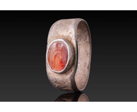 Ca. AD 50 - 300.A carnelian intaglio engraved with a winged female figure standing in profile, depicting Victory. The figure 