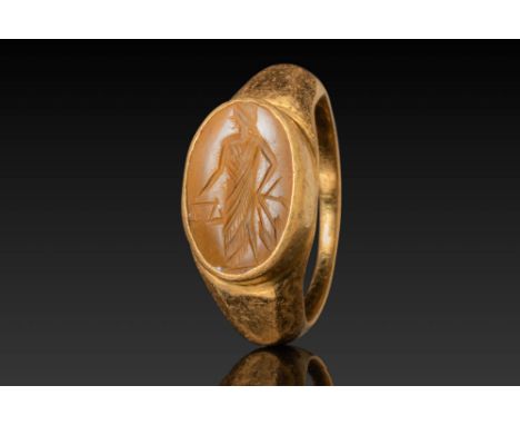 Ca. AD 200 - 300. A jasper intaglio engraved with a standing figure of Justitia facing left. She is shown wearing a draped ga