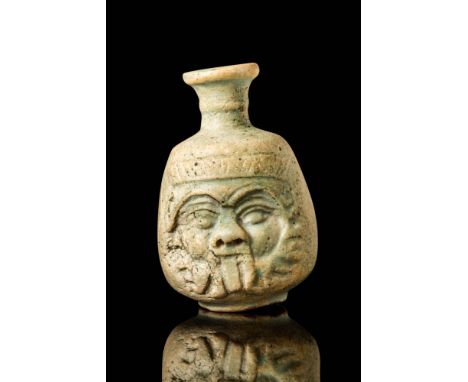 Late Period, Ca. 664 - 332 BC. A faience bottle with a short, funnel-shaped neck and a rounded body decorated with a moulded 