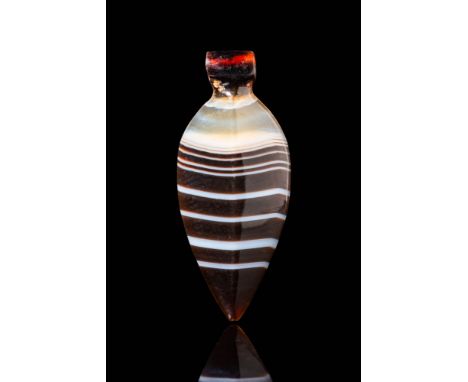 New Kingdom, Ca. 1550 - 1069 BC. A banded agate pendant with an elongated, leaf-shaped body tapering to a pointed tip. The su