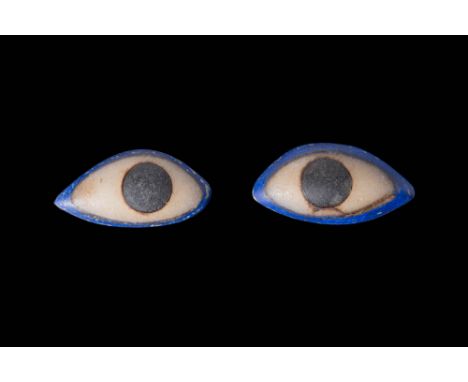 Late Period, Ca. 664 - 332 BC. A pair of glass and lapis inlays from an anthropoid coffin, each shaped to resemble a human ey