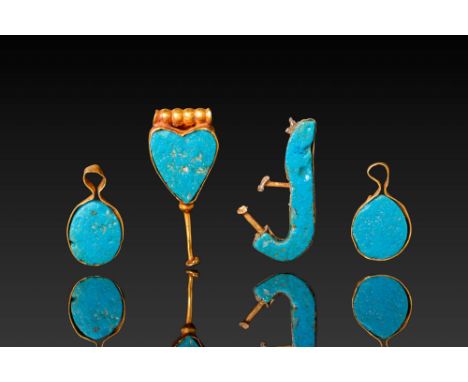 Middle Kingdom, Ca. 2055 - 1790 BC. A collection of four gold pendants with turquoise inlays, including two oval, one heart-s