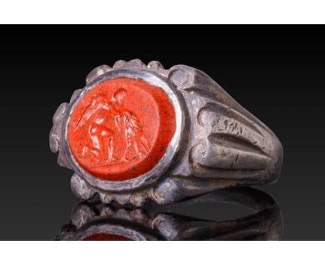 Ca. AD 300.A red stone intaglio engraved with a depiction of kneeling Eros with delicate anatomical detailing and finely rend