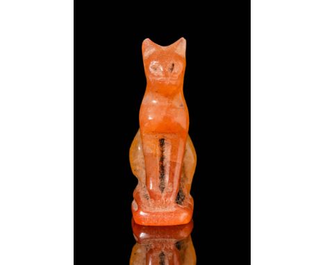 Late Period, Ca. 664 - 332 BC. A carnelian cat amulet, carved in a seated position with an upright posture. The head features