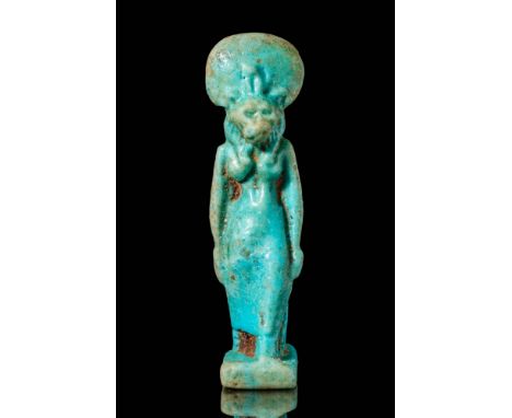 Late Period, Ca. 664 - 332 BC. A faience amulet depicting a standing lion-headed goddess Sekhmet. The figure wears a triparti