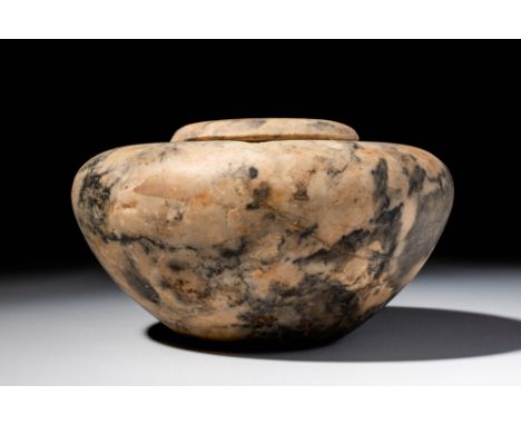 Predynastic Period, Ca. 3600 - 3100 BC. A squat stone vessel with a wide, rounded shoulder and raised pronounced rim. The bod