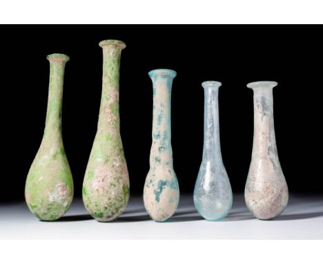 Ca. AD 1 - 300.A collection of five blown glass unguentaria, each with pear-shaped lower body and elongated cylindrical neck 