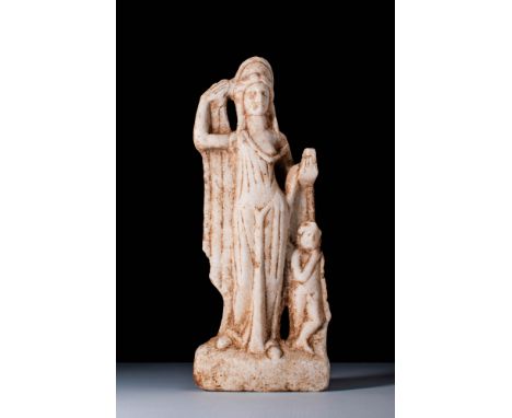 Ca. 200 BC. A marble figure depicting a draped female figure identified as Aphrodite, wearing a high stephane and raising her