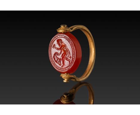Ca. 500 BC. A carnelian intaglio engraved with a figure of Hephaestus advancing to the left, holding a hammer in his raised l