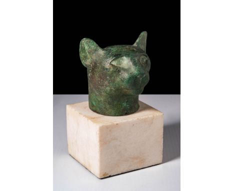 Late Period, Ca. 64 - 332 BC.A bronze head of a cat with alert ears, rounded cheeks, and recessed eyes, possibly for inlays. 
