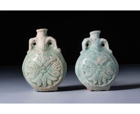 Ca. 30 BC - AD 200. A pair of turquoise-glazed faience flasks, each with a rounded and flattened body, and a short, cylindric