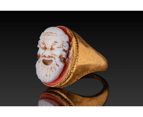 Ca. AD 200 - 300. A cameo carved in layered agate presenting the expressive face of a bearded theatrical mask in high relief,