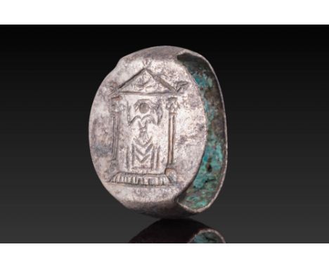 Ca. 400 - 300 BC. A silver ring with a flat-section hoop and an oval bezel engraved with a stylised temple façade. The pedime