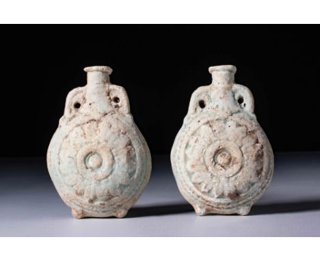 Ca. 30 BC - AD 200. A pair of turquoise-glazed faience flasks, each with a rounded and flattened body, and a short, cylindric