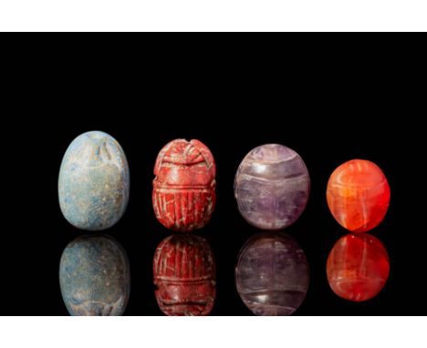 Middle Kingdom to Late Period, Ca. 2055 - 332 BC. A collection of four scarabs. The first on the left has a smooth, rounded s